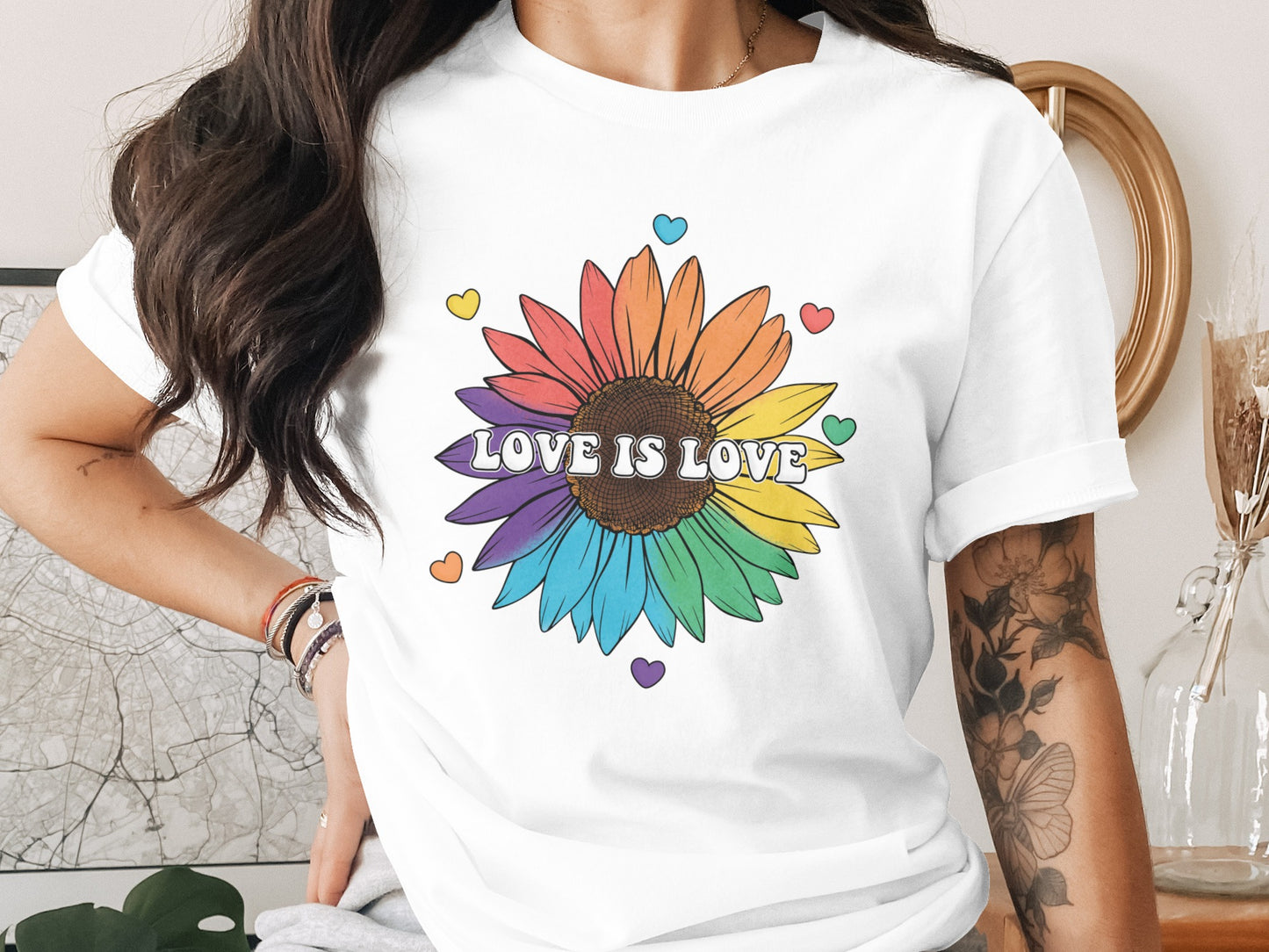 White t-shirt with rainbow sunflower and "LOVE IS LOVE" text.