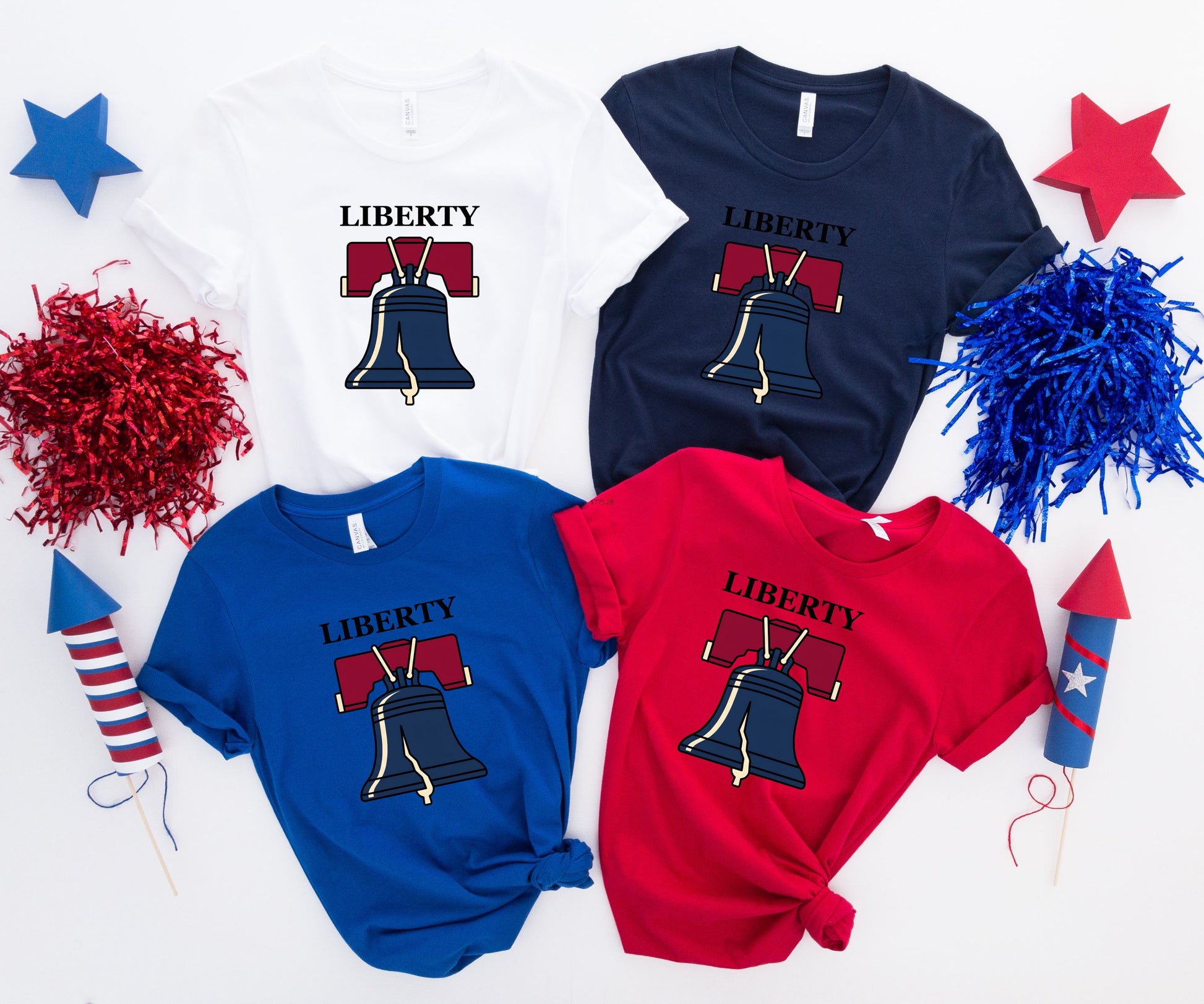 Four Liberty Bell t-shirts in white, navy, royal blue, and red.