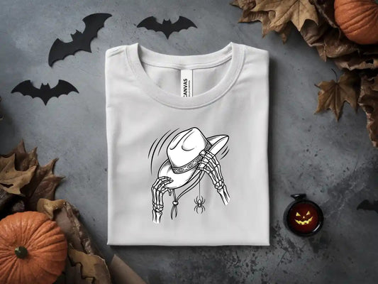 White t-shirt with a skeleton hand holding a cowboy hat and a spider.