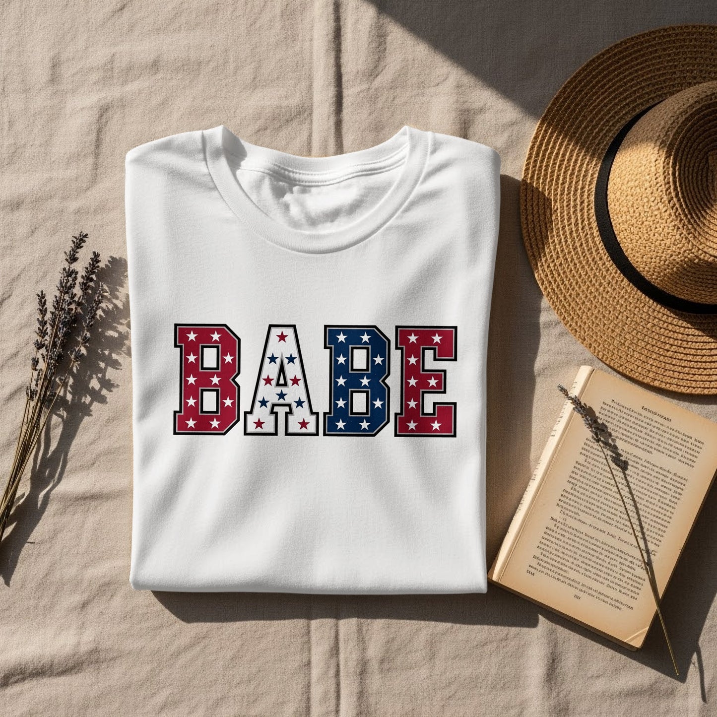 White t-shirt with "BABE" in red, white, and blue star pattern.