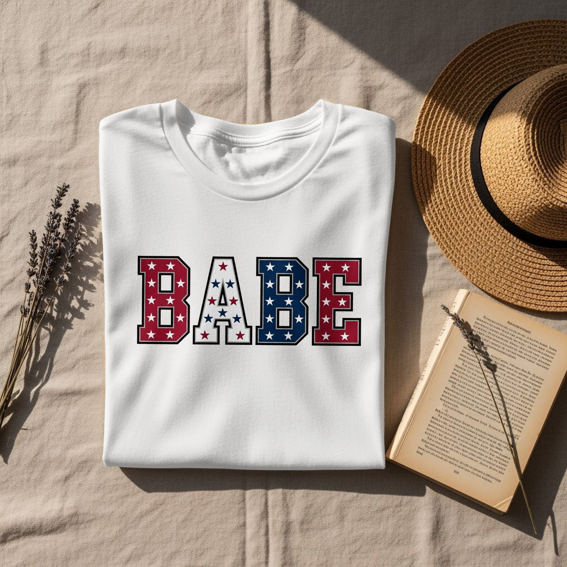 White t-shirt with "BABE" in red, white, and blue star pattern.