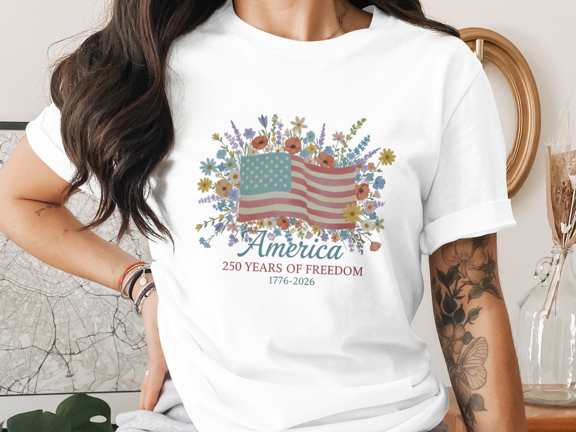 White t-shirt with floral American flag and text "America 1776-2026".