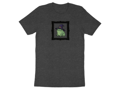 Dark gray t-shirt with a black framed illustration of a green frog wearing a witch hat.
