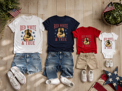 Adult and child patriotic t-shirts and denim shorts on wood.