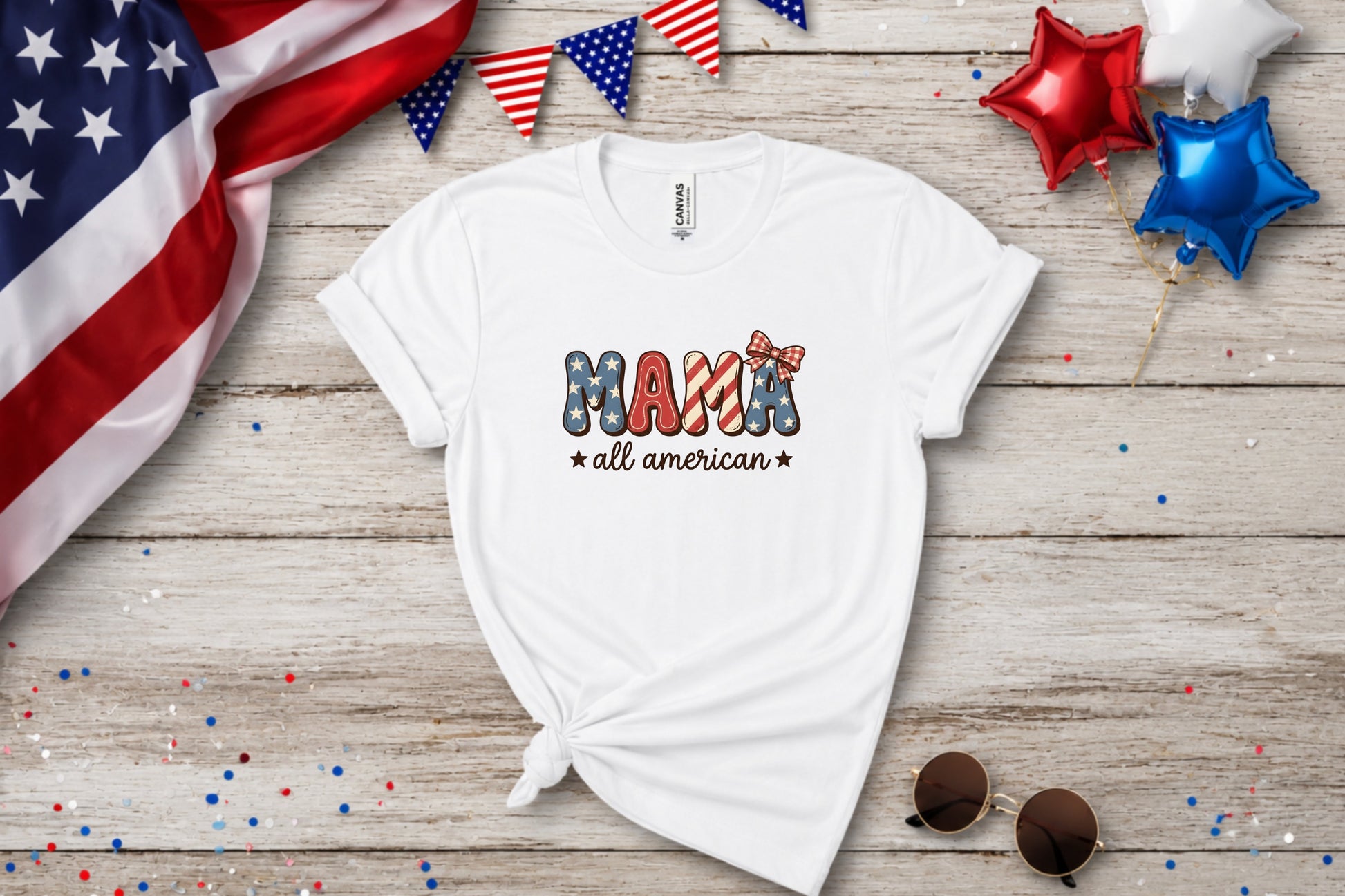 White t-shirt with "Mama all american" in patriotic text and stars and stripes ribbon.