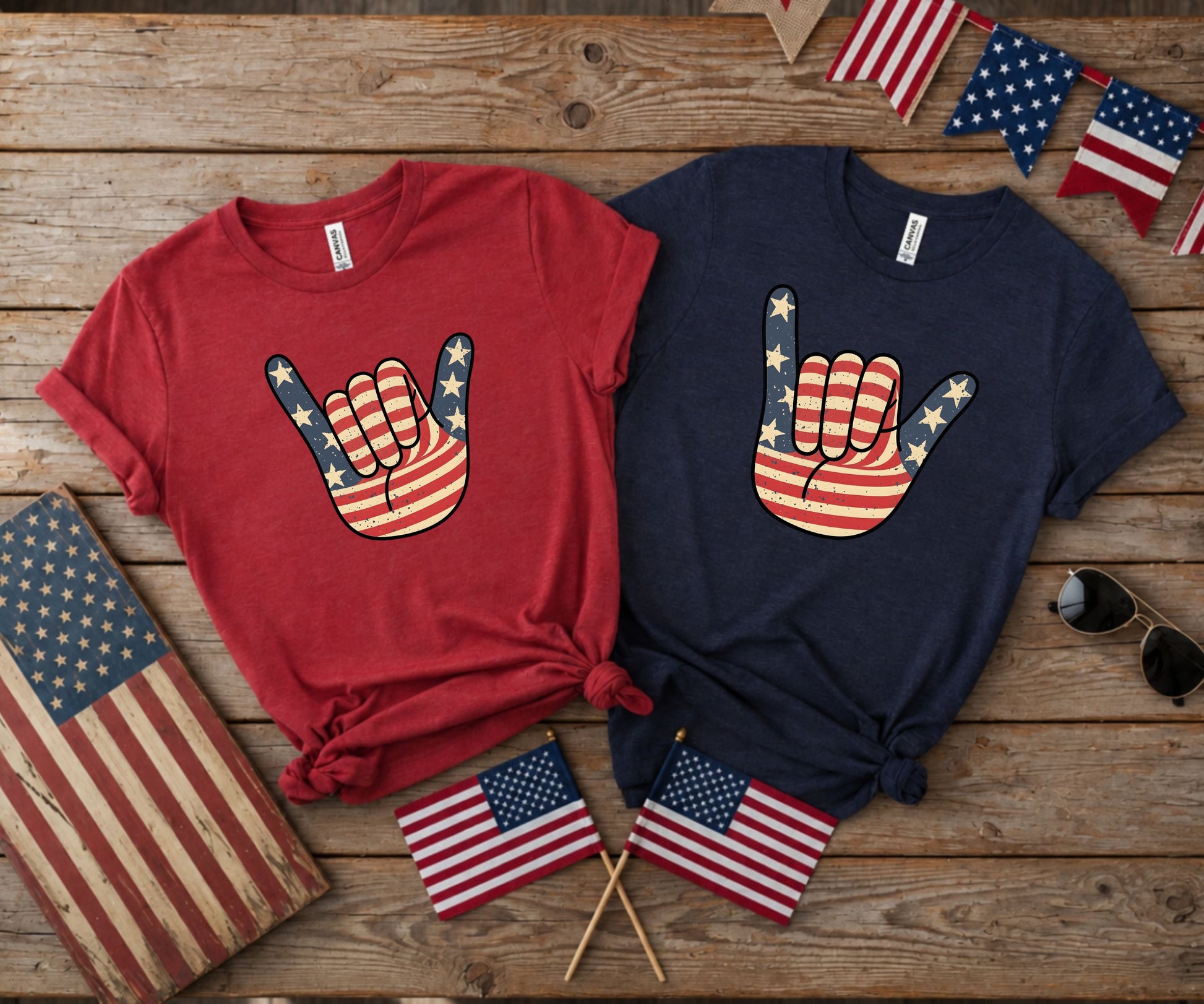 Two graphic tees featuring American flag hand signs and patriotic flags.