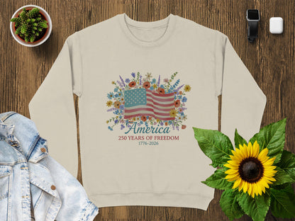 Cream sweatshirt with American flag, floral design, and "America 250 Years of Freedom" text.