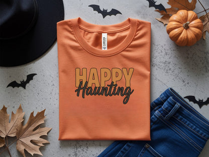 Orange t-shirt with "Happy Haunting" text, Halloween decorations.