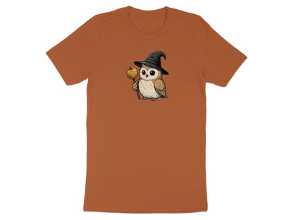 Brown t-shirt with a cartoon owl wearing a witch hat holding a golden apple on a stick.