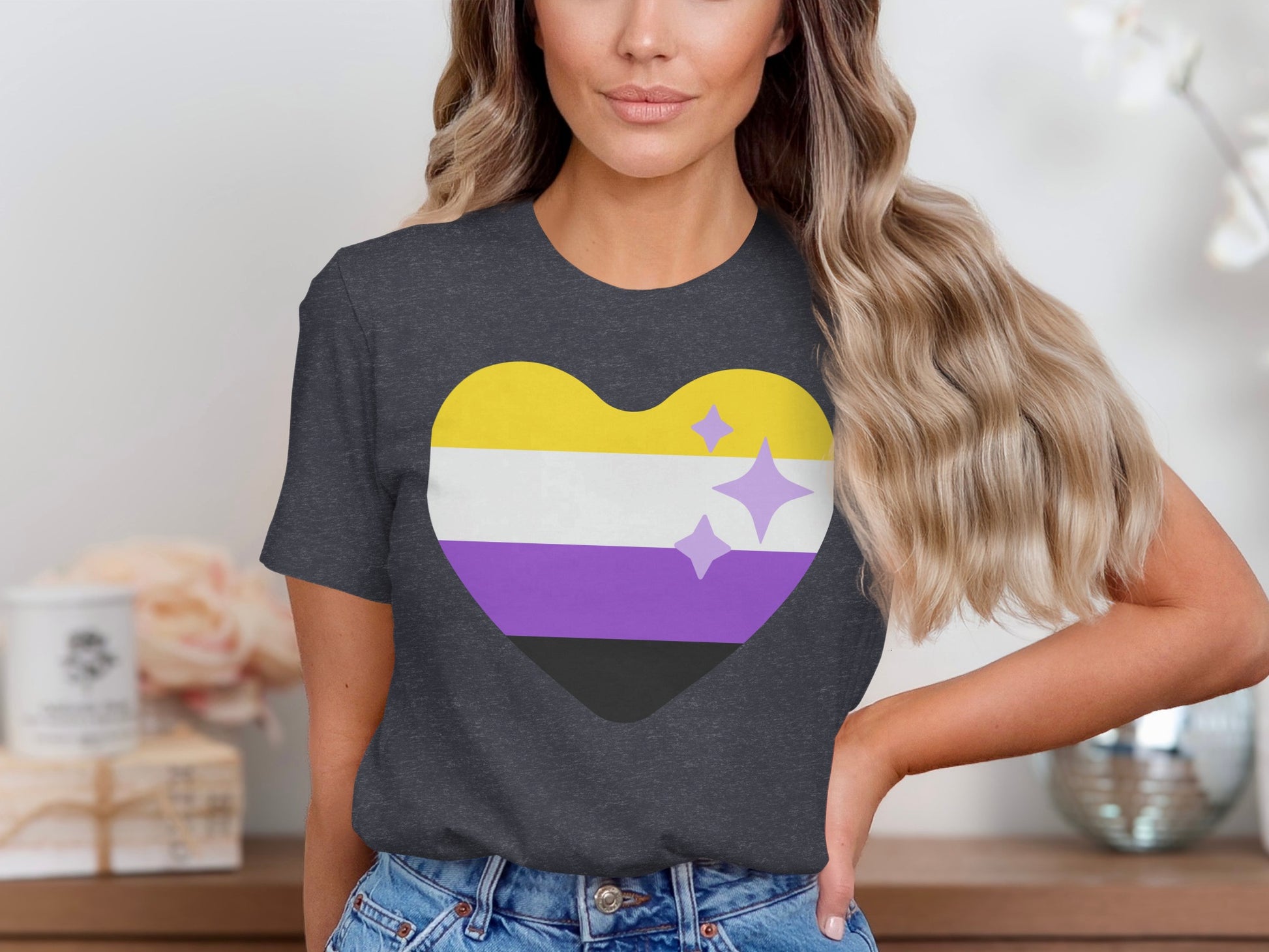 Dark grey t-shirt with a non-binary pride heart in yellow, white, purple, and black.