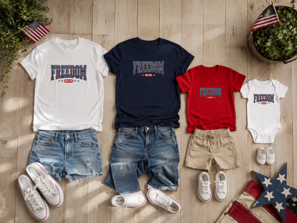 T-shirts and onesie with "FREEDOM EST 1776" text, denim shorts, and sneakers.